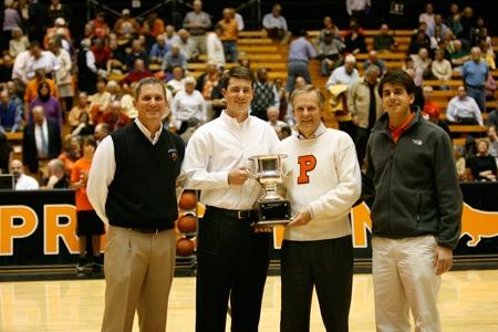 Men’s golf coach Will Green, John Sawin ’06, Stu Francis ’74, and Greg Stamas ’10 with a Princeton-Penn alumni challenge trophy.