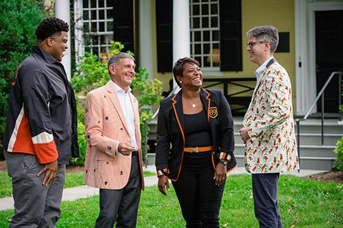Monica Moore Thompson and her alumni council leadership team, talking and laughing in front of Maclean House